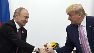 Vladimir Putin shakes hands with Donald Trump in 2019 (Susan Walsh/AP)