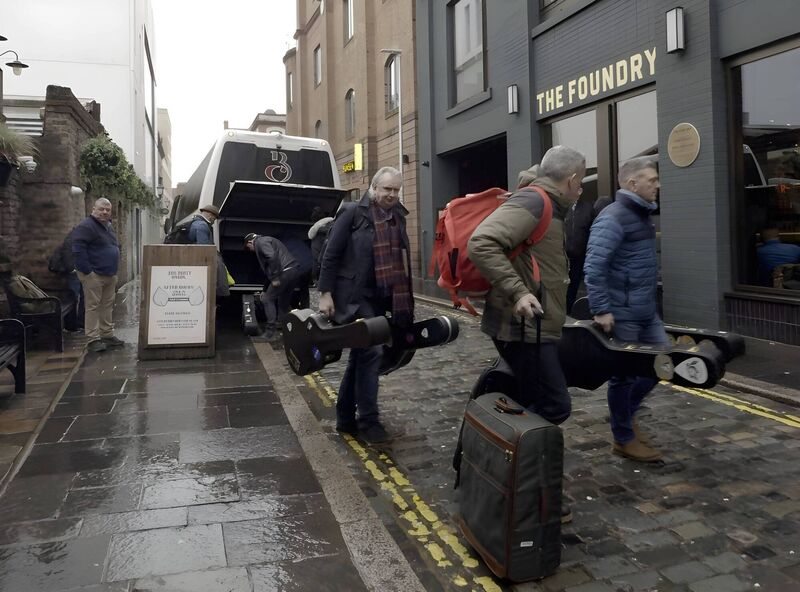 The White Horse Guitar Club, unloading the tour bus ahead of their Belfast show. 