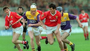 <p>Tomas Mulcahy of Cork looses his hurley in the 1993 National Hurling League Final with Wexford </p>