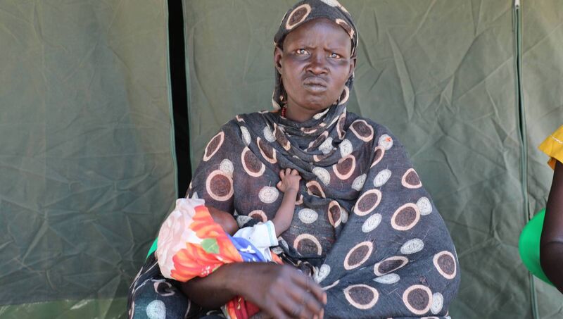 Sudanese refugee Mary Atyeng at the Kiir Adem border crossing with her baby. Picture: Eugene Ikua/ Concern Worldwide