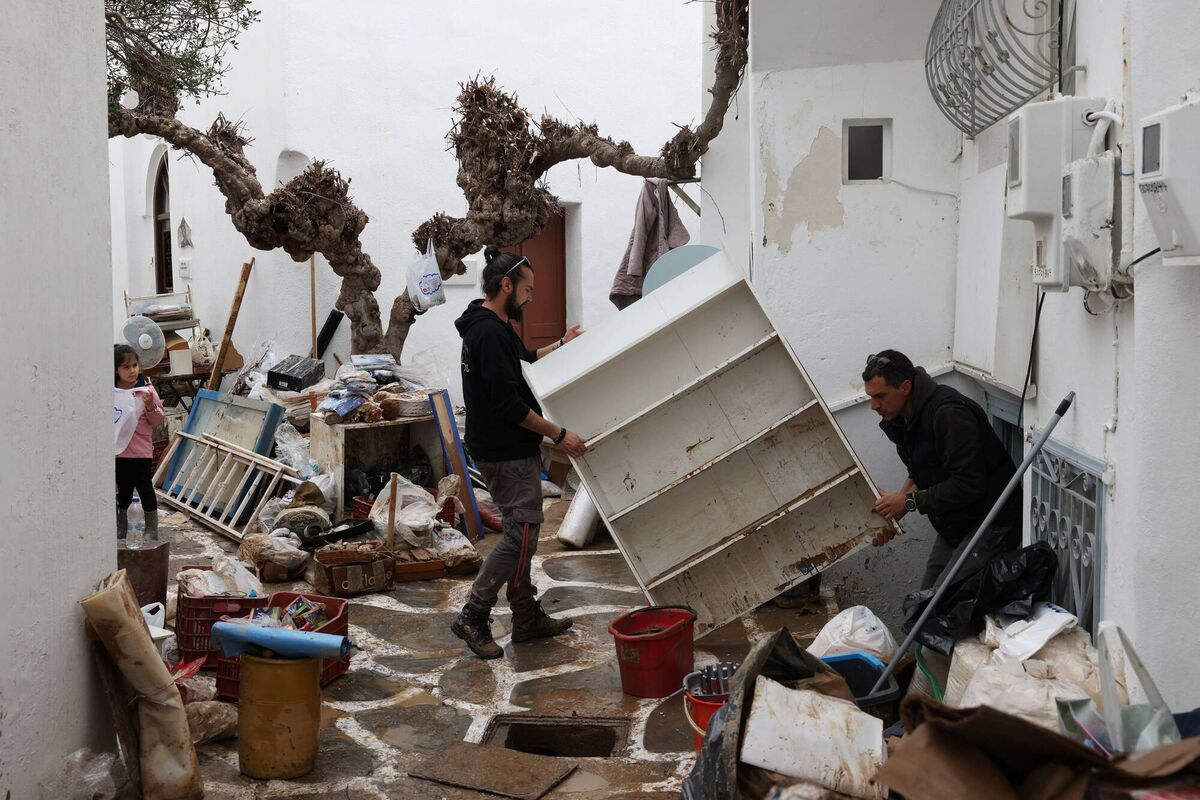 People remove the goods from a shop, after heavy rainstorms flood roads, on the Island of Paros. Picture: Costas Baltas/Getty Images