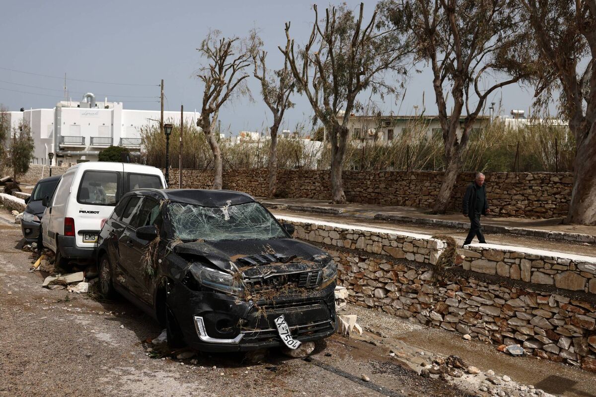 Damaged cars are seen, after heavy rainstorms flood roads. Picture: Costas Baltas/Getty Images
