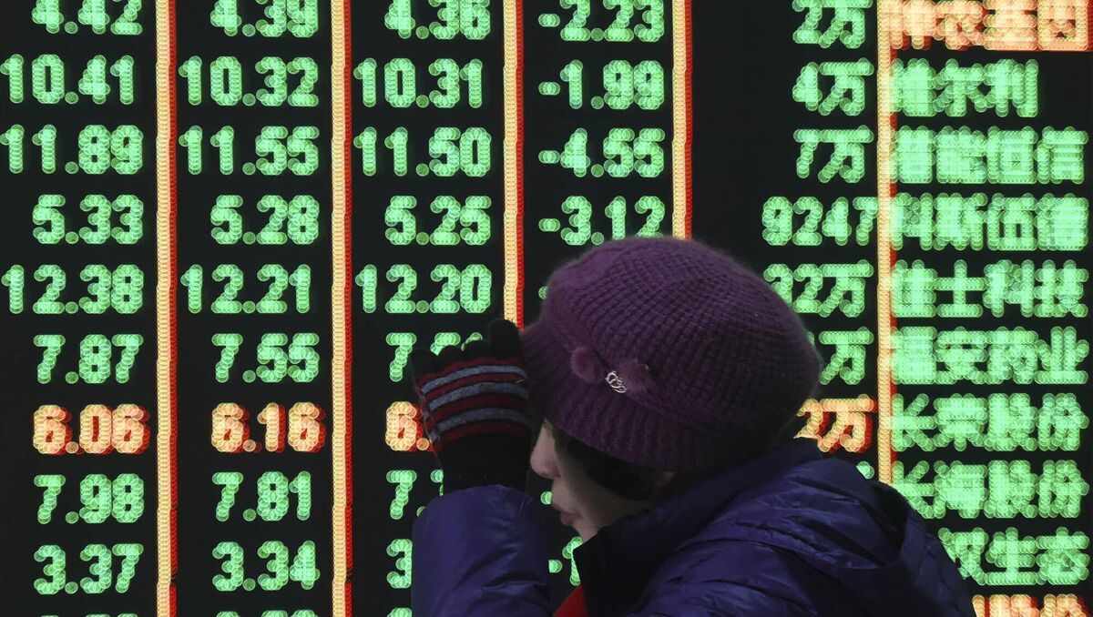 A woman reacts in front of an electronic screen displaying stock prices at a brokerage house in Hangzhou in east China's Zhejiang province on  Monday. Picture: Chinatopix Via AP