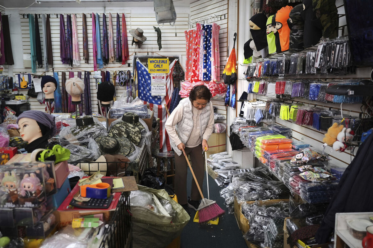 Store owner Kyung Sook Im cleans the floor of her shop in the Toy District of Los Angeles, Wednesday, April 9, 2025, where the majority of the merchandise is imported from China. (AP Photo/Jae C. Hong)