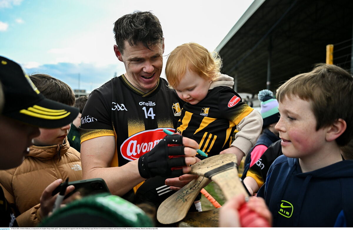 Reid, accompanied by daughter Harper, signs autographs for supporters after the Allianz Hurling League Division 1A match between Kilkenny and Limerick. File picture: Sam Barnes/Sportsfile.