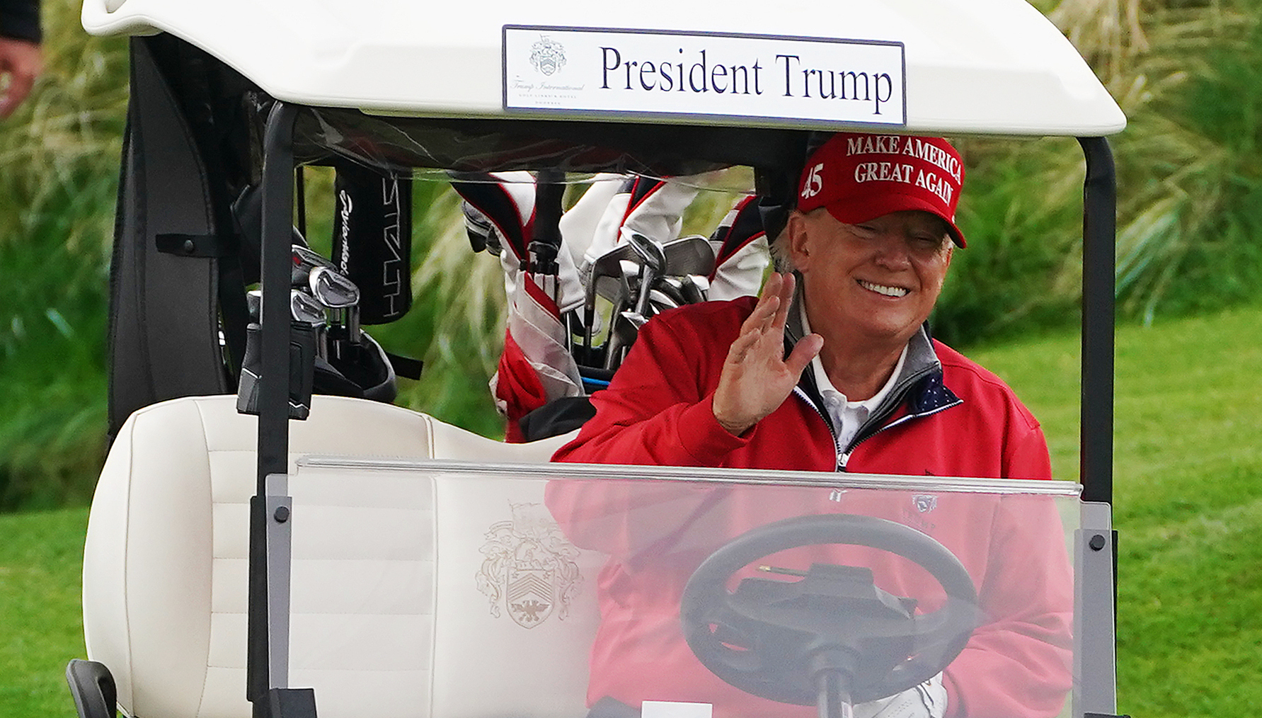 ‘Completely out of touch’: golf and dinners for ‘king’ Trump as economy melts down
