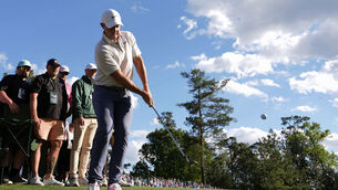 <p>Rory McIlroy chips to the green on the 14th hole during the third round at the Masters. Pic: Julia Demaree Nikhinson/AP</p>