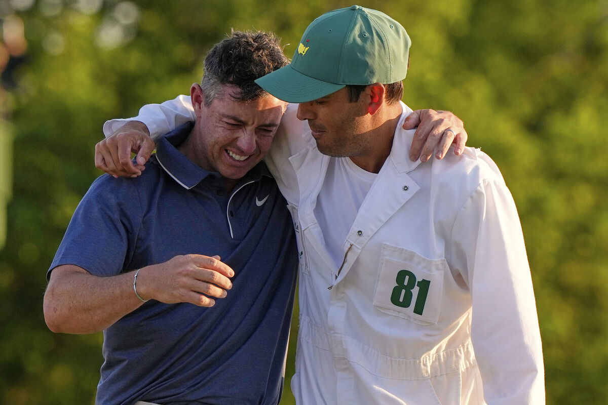 Rory McIlroy hugs caddie Harry Diamond, right, after winning. Pic: David J. Phillip/AP