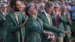 <p>Scottie Scheffler puts the green jacket on Masters winner Rory McIlroy. Picture: AP Photo/Matt Slocum</p>