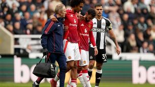 <p>Manchester United’s Joshua Zirkzee, second left, is helped from the pitch after picking up an injury (Owen Humphreys/PA)</p>