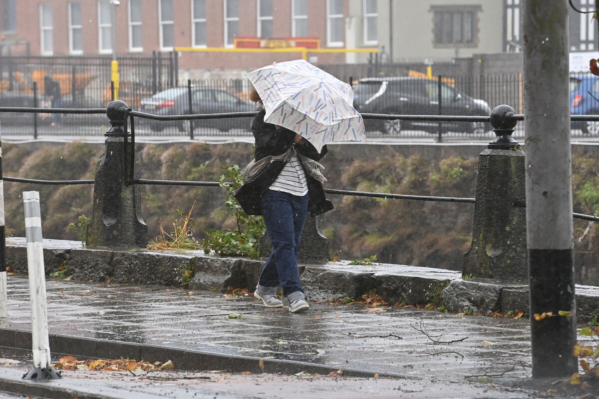 A woman making her way through the wind an rain along Sullivans Quay, Cork. Picture Dan Linehan