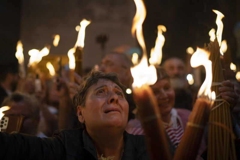 A Christian Orthodox pilgrim holds a candle during the Holy Fire ceremony. Picture: AP Photo/Leo Correa A Christian Orthodox pilgrim holds a candle during the Holy Fire ceremony. Picture: AP Photo/Leo Correa