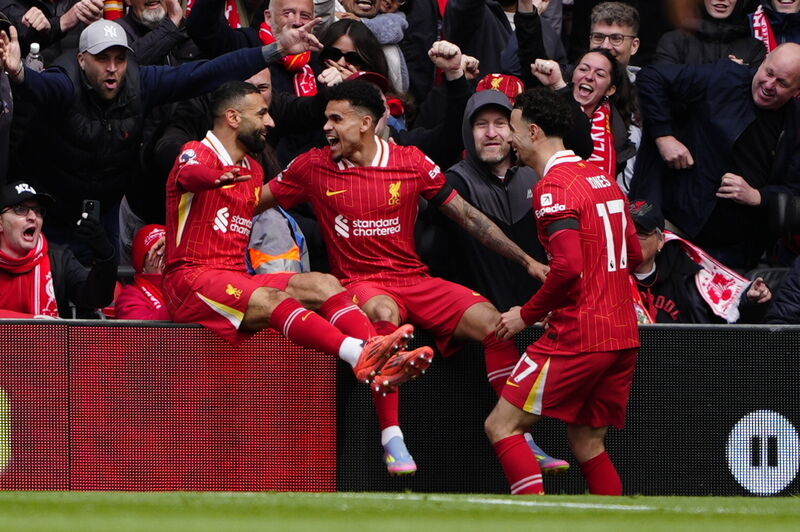 RED MACHINE: Liverpool's Luis Diaz (centre) celebrates with Mohamed Salah (left) and Curtis Jones (right) after scoring his sides first goal during the Premier League match at Anfield, Liverpool. Pic: Peter Byrne/PA Wire