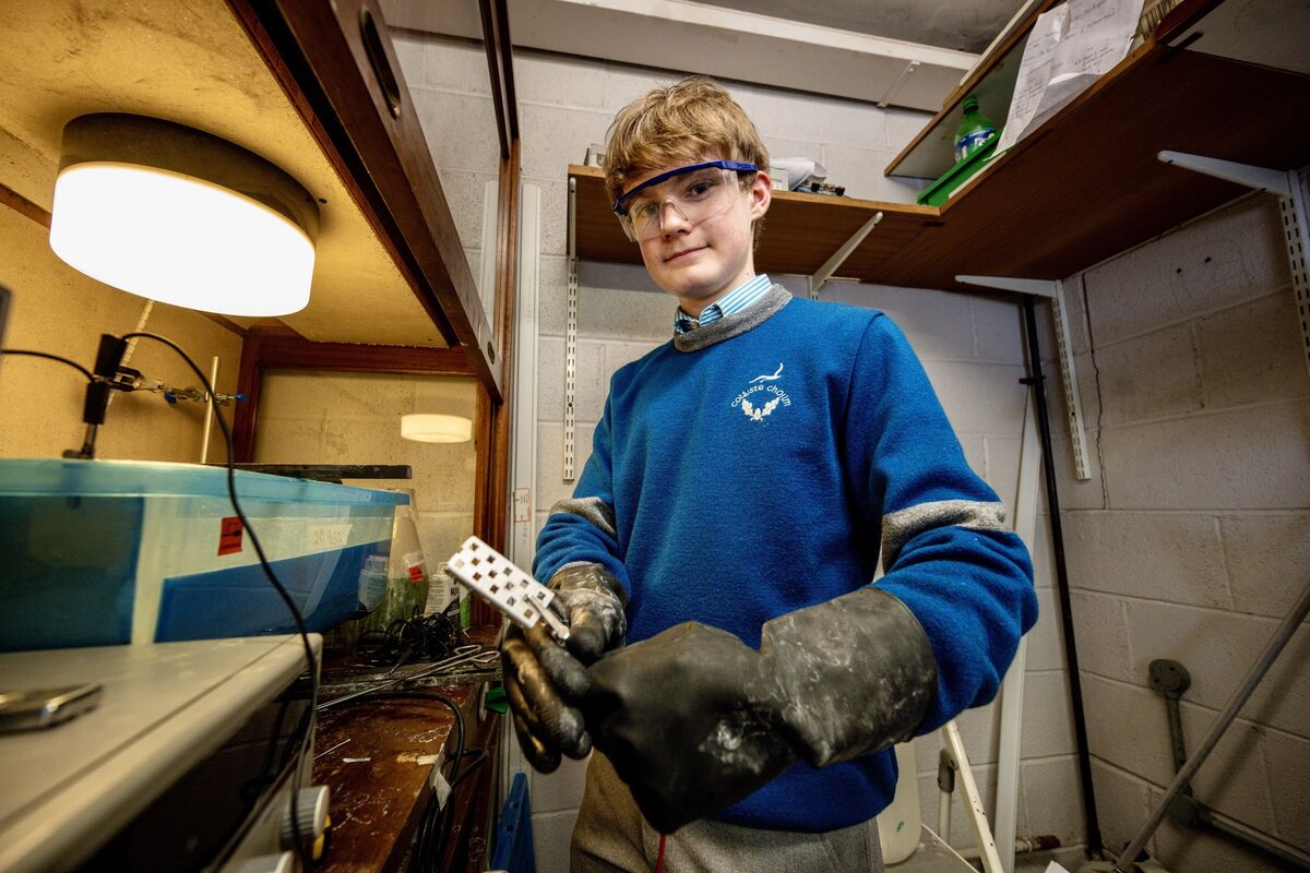 Cillian O’Toole works on electroplating the team’s robot, giving it a fresh green finish ahead of its journey to Texas. Picture: Chani Anderson