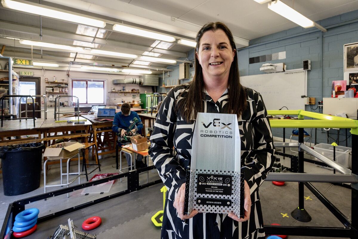 Physics teacher Tara Lokhurst, who was awarded Best Teacher at the recent VEX competition in MTU, pictured with her award and the Gaelcholáiste Choilm robotics team. Picture: Chani Anderson