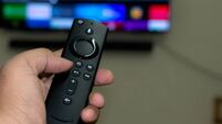 Amazon fire stick TV remote in hand