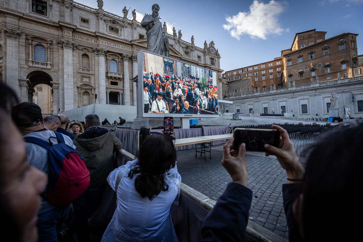 Mourners videoing a video set up to show footage not just of the pope lying in state but also his funeral. Picture: Neil Michael.