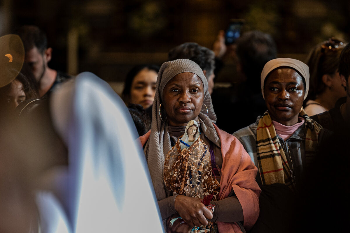 A member of a religious congregation at a vigil for the pope by one of the entrances to St Peter's. Picture: Neil Michael.