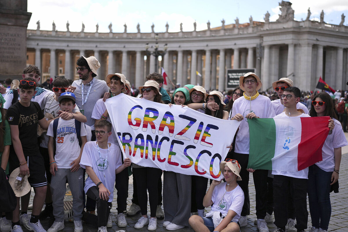 Youngsters hold a banner during the funeral of Pope Francis in St. Peter's Square at the Vatican, Saturday, April 26, 2025. (AP Photo/Andreea Alexandru)