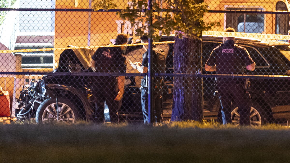 Vancouver police examine a black car suspected to be involved at a scene after a vehicle drove into a crowd at the Lapu Lapu Festival in Vancouver. Picture: Rich Lam/The Canadian Press via AP