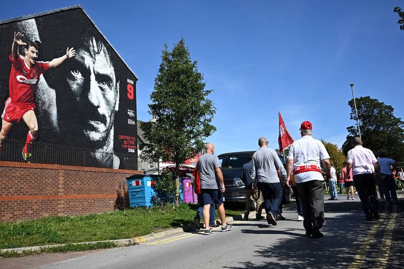 Liverpool's supporters walk past a mural depicting Liverpool's former player Ian Rush as they arrive to attend a Premier League football match Photo by PAUL ELLIS/AFP via Getty Images Liverpool's supporters walk past a mural depicting Liverpool's former player Ian Rush as they arrive to attend a Premier League football match Photo by PAUL ELLIS/AFP via Getty Images