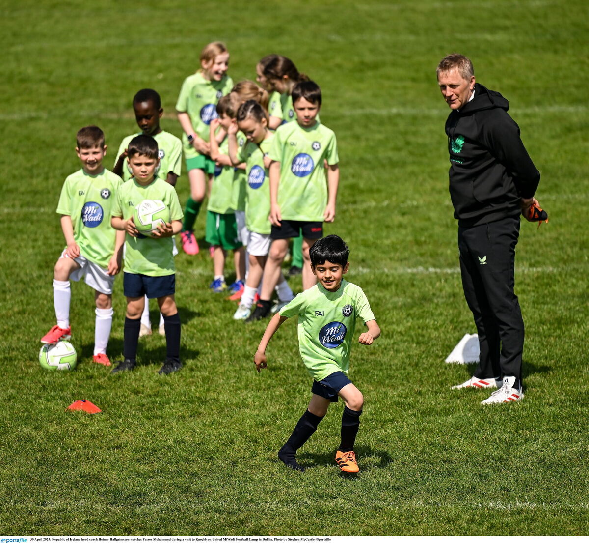 Republic of Ireland head coach Heimir Hallgrimsson watches Yasser Mohammed during a visit to Knocklyon United MiWadi Football Camp in Dublin. Pic: Stephen McCarthy/Sportsfile.