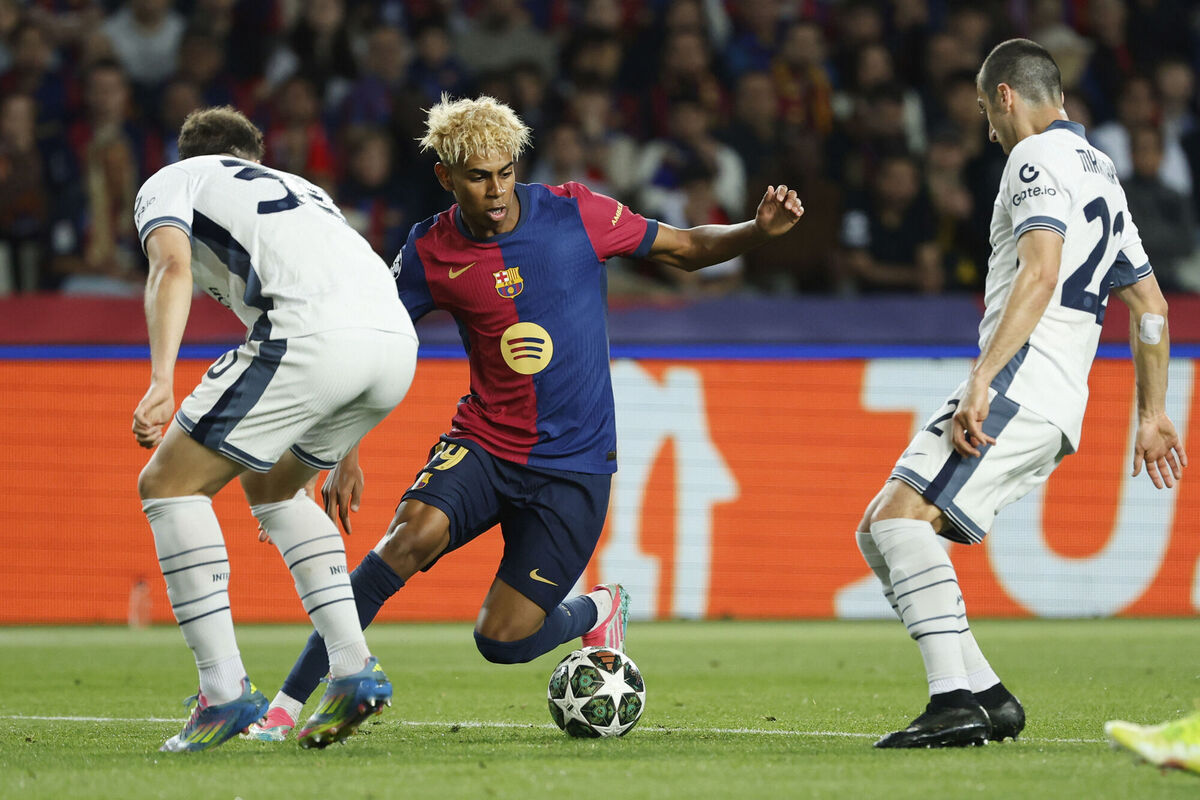 Barcelona's Lamine Yamal, centre, is challenged by Inter Milan's Carlos Augusto, left, and Henrikh Mkhitaryan. Pic: AP Photo/Joan Monfort