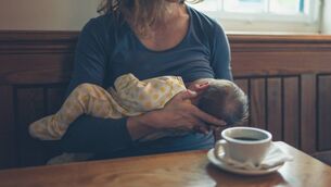 <p>A young mother breastfeeding her baby in a café while having a coffee. If we're banning children from cafés, let's not forget who else we are excluding. File picture</p>
