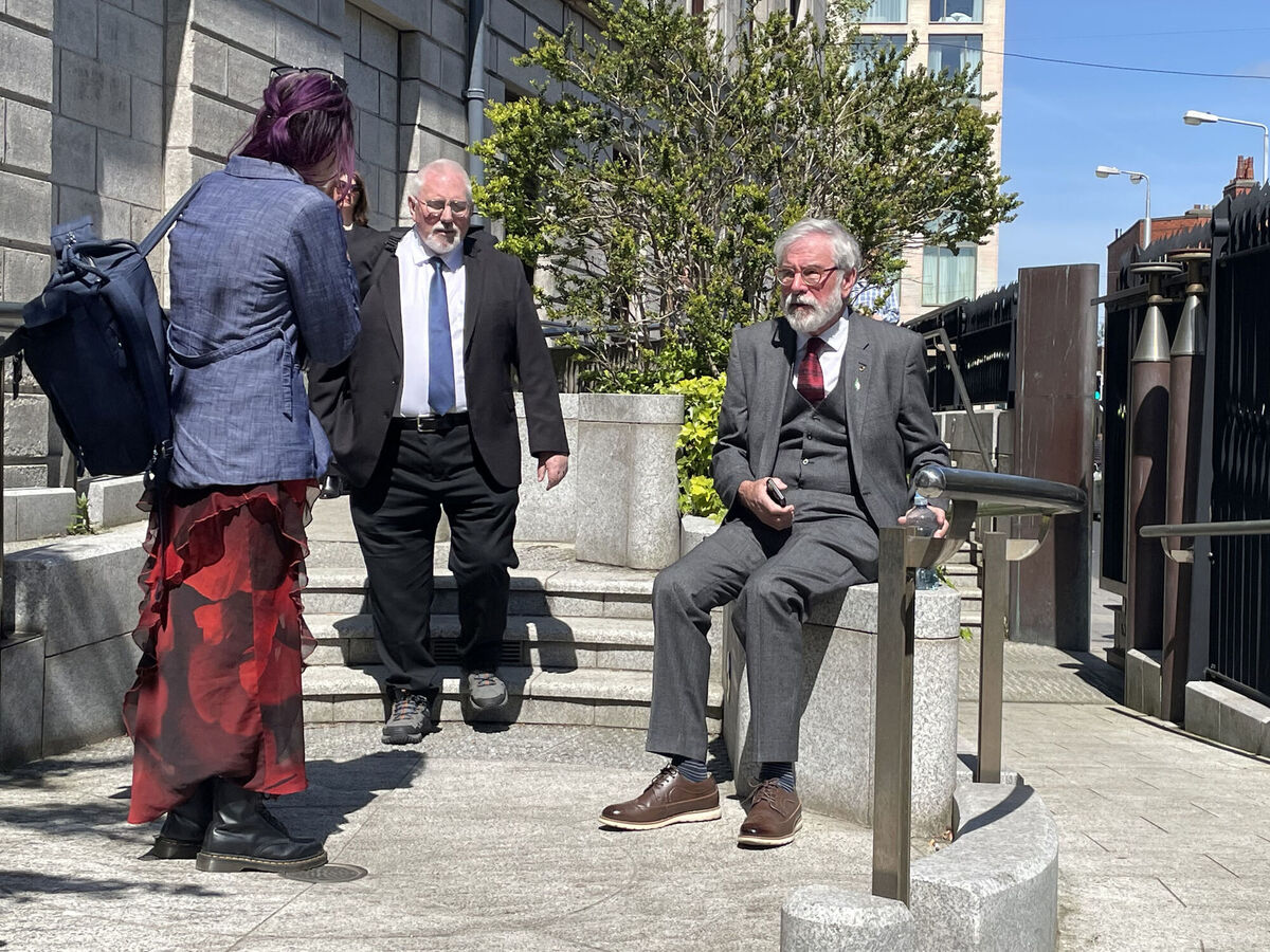 Former Sinn Féin president Gerry Adams (right) sitting down after leaving the High Court in Dublin today. Photo: Grainne Ni Aodha/PA