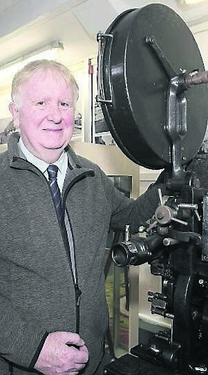 Ed Guiry, museum curator, with a 1924 cinematic projector at Youghal Film and Photography Museum. Ed Guiry, museum curator, with a 1924 cinematic projector at Youghal Film and Photography Museum.