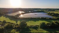 Aerial view of the solar panel in solar farm in evening sun light.