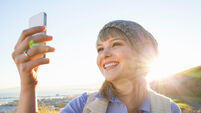 Young woman taking selfie with smartphone