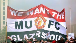<p>Fans hold up a banner as they protest against the Glazer family, owners of Manchester United.</p>