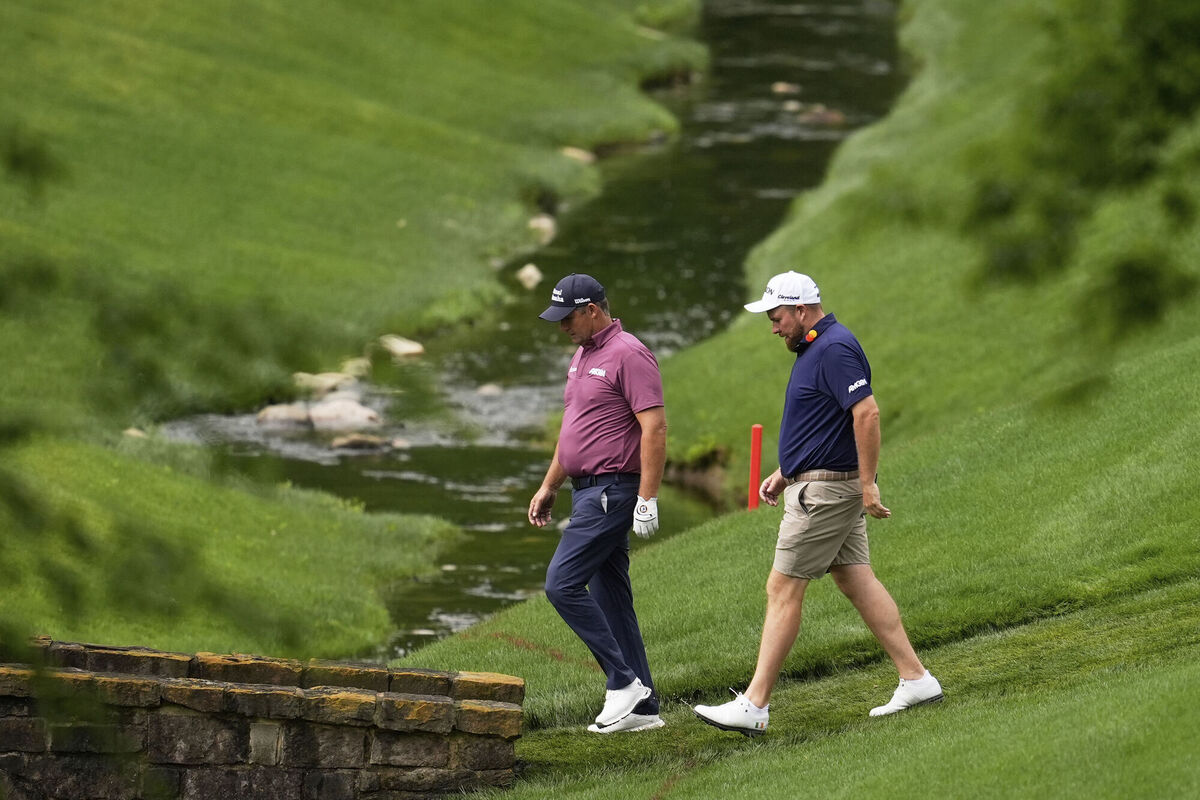 Padraig Harrington and Shane Lowry walk on the 13th hole during a practice round for the PGA Championship at the Quail Hollow Club. Pic: AP Photo/George Walker IV
