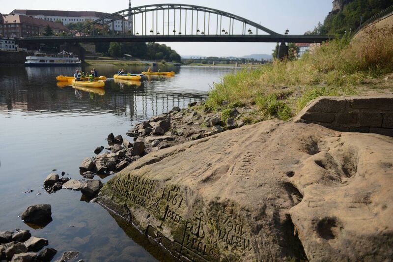 'Hunger Stone' at Decin, Czech Republic revealed by the low water level of the Elbe river. Once an ominous harbinger of low water and hard times the carved stone has in the past been exposed by drought spanning much of Europe — seen here in August 2018. Picture: Michal Cizek /AFP via Getty Images