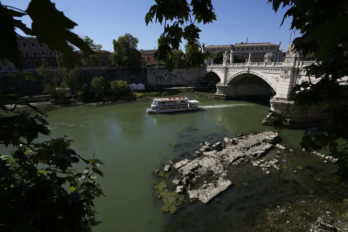 A boat passes by the ruins of the ancient Roman Neronian bridge, usually submerged by the Tiber, in Rome, in June 2022. Picture: AP Photo/Alessandra Tarantino