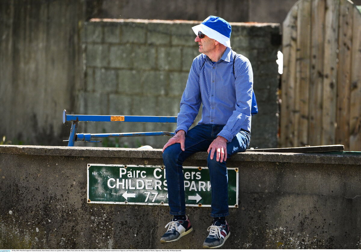 Waterford supporter Eamon Kennedy, from Clonmel, relaxes on a garden wall, at Childers Park. Pic: Ray McManus/Sportsfile