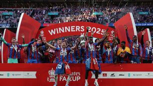 <p>Crystal Palace's Marc Guehi (centre right) and Joel Ward (centre left) hold the trophy as Crystal Palace players celebrate after the FA Cup final win over Manchester City. Photo by ADRIAN DENNIS/AFP via Getty Images) </p>