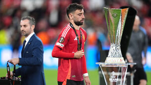<p>Manchester United’s Bruno Fernandes walks past the trophy following the UEFA Europa League final (Adam Davy/PA)</p>