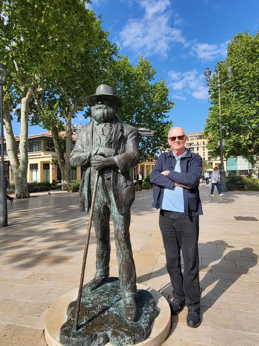 Writer Jim Gallagher with a statue of Paul Cezanna.
