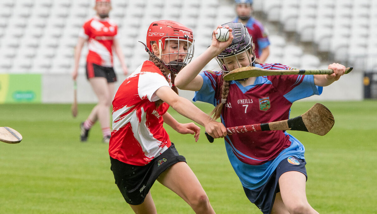  C2 FINAL: Emma O'Mahony of Berrings attempts to break away from Watergrasshill's Shona O'Neill. Pic: Howard Crowdy