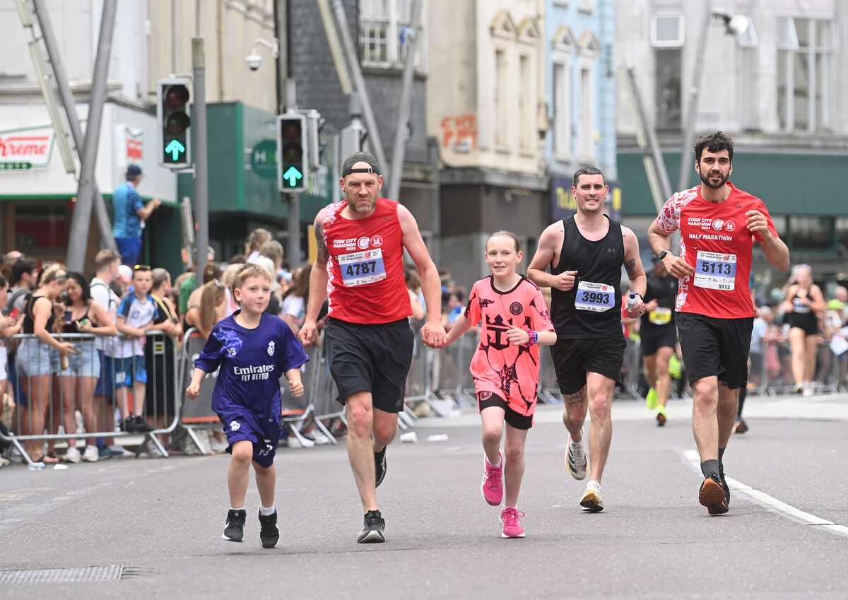  Brian Dilworth was joined by his children Lewis and Alice at the finish line of the Cork City Marathon on Sunday, June 2, 2024. Picture: Larry Cummins.