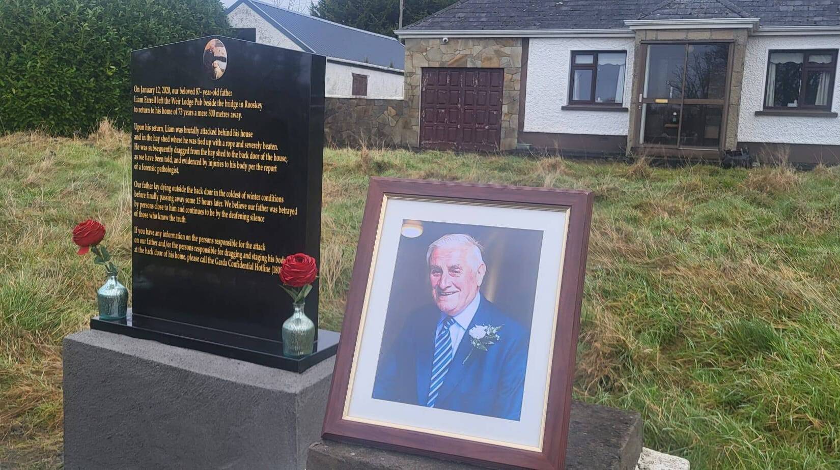 The newly unveiled plaque appealing for information and a photograph of the late Liam Farrell at his home in Roosky.
