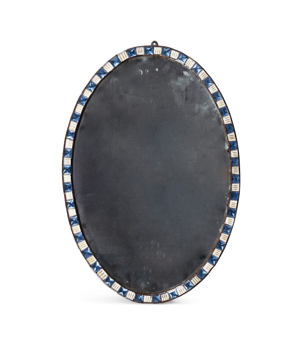 A Regency oval beaded mirror at James Adam.