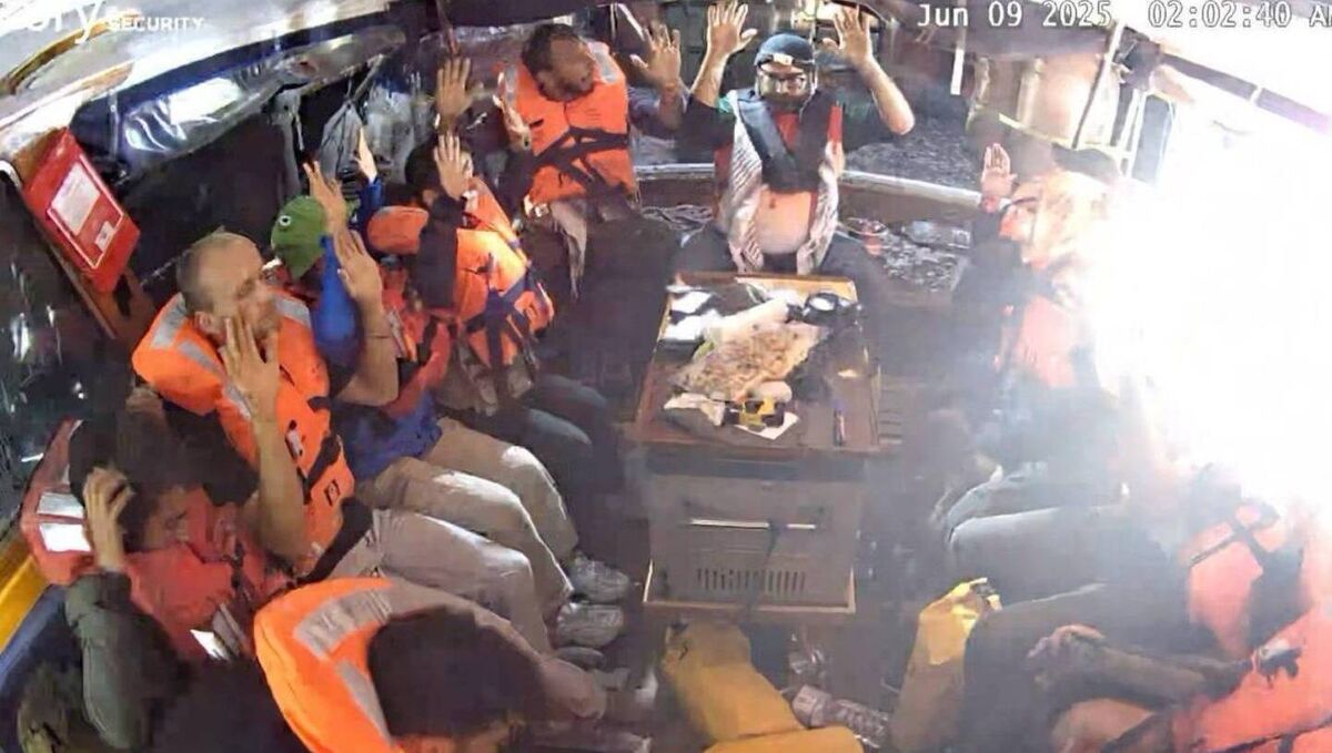 Rima Hassan, a French member of the European Parliament, posted this photo on X, showing the crew seated on the boat, all wearing life jackets, with their hands in the air. Picture: Rima Hassan/X