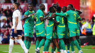 <p>Senegal celebrate Ismaila Sarr’s equaliser as England’s Kyle Walker looks frustrated (Mike Egerton/PA)</p>