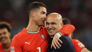 <p>KNEES ARE KILLIN' ME BOSS: Cristiano Ronaldo and Portugal manager Roberto Martinez embrace after their penalty shoot out win in the Nationd League finak in Munich. Pic: Alexander Hassenstein/Getty Images</p>