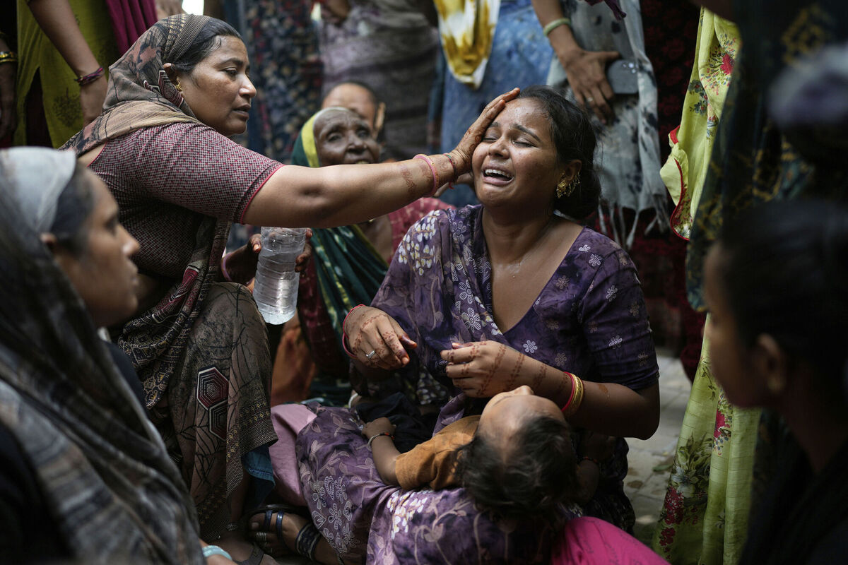 A relative of a victim of the Air India plane crash is comforted as she breaks down at a hospital in Ahmedabad, India, Friday, June 13, 2025. (AP Photo/Rafiq Maqbool)