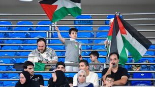 <p>Palestinine's fans wave national flags ahead of the 2026 FIFA World Cup Asian Qualifier football match between Kuwait and Palestine at Jaber Al-Ahmad International StadiumÂ in Kuwait City on June 5, (Photo by -/AFP via Getty Images) </p>