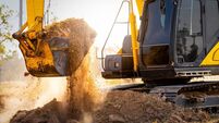 Close-up of excavator at construction site. Backhoe digging soil for earthwork and construction business. Excavating machine at